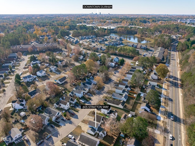 birds eye view of property with a water view and a residential view