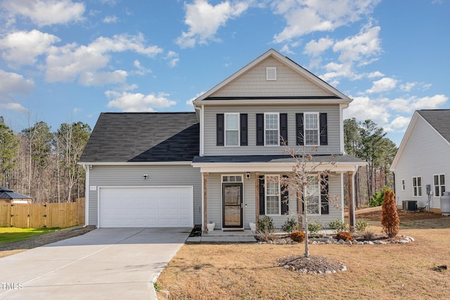 view of front property with central AC unit, a garage, and a front yard