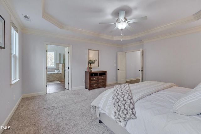 bedroom featuring a tray ceiling, ornamental molding, carpet, and baseboards