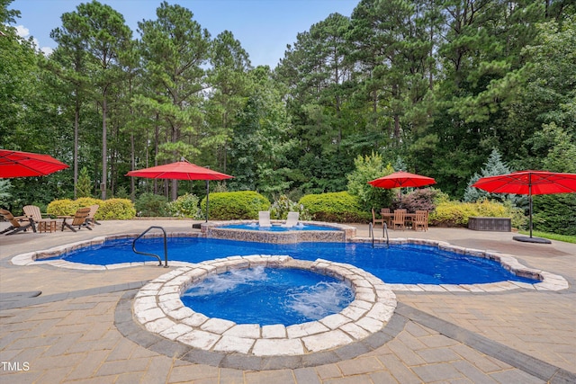 view of swimming pool with outdoor dining area, a patio area, and a pool with connected hot tub