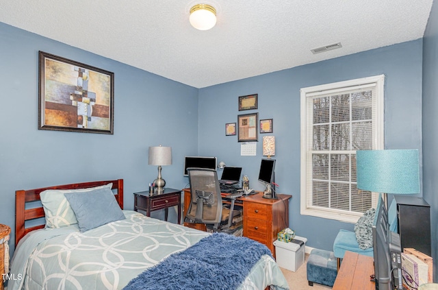 bedroom featuring baseboards, carpet, visible vents, and a textured ceiling