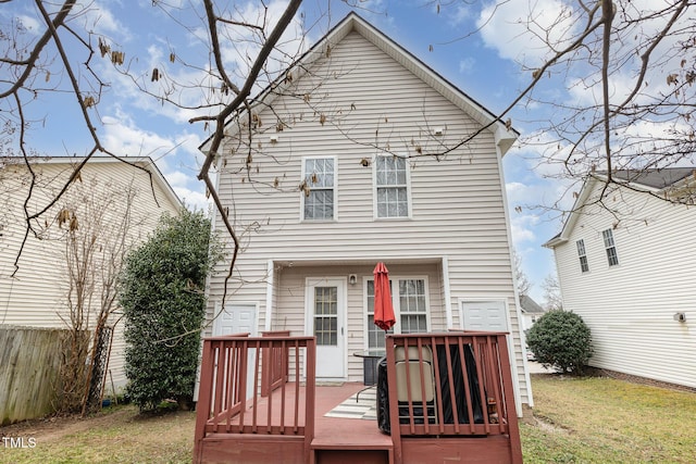 rear view of property with central AC unit, a wooden deck, a lawn, and fence