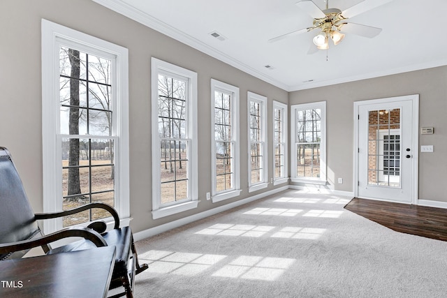 sunroom / solarium with ceiling fan and visible vents