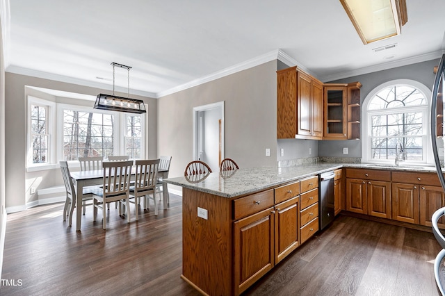 kitchen featuring light stone counters, dark wood finished floors, brown cabinetry, glass insert cabinets, and a peninsula