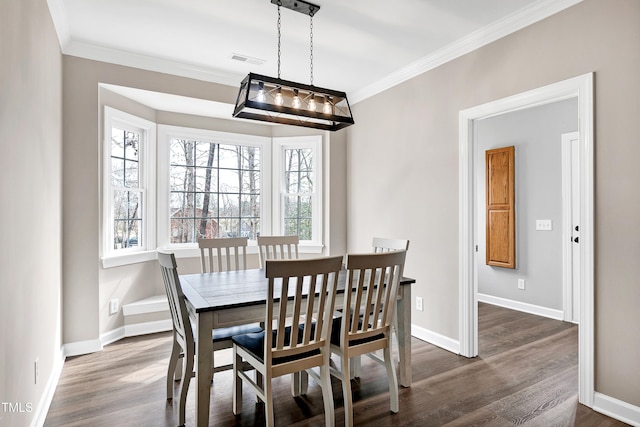 dining space with plenty of natural light, visible vents, and crown molding