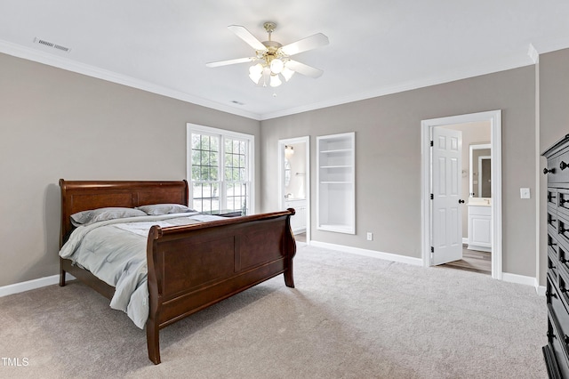 bedroom with visible vents, crown molding, light carpet, and baseboards