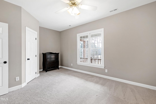 unfurnished bedroom with a ceiling fan, carpet, visible vents, and baseboards