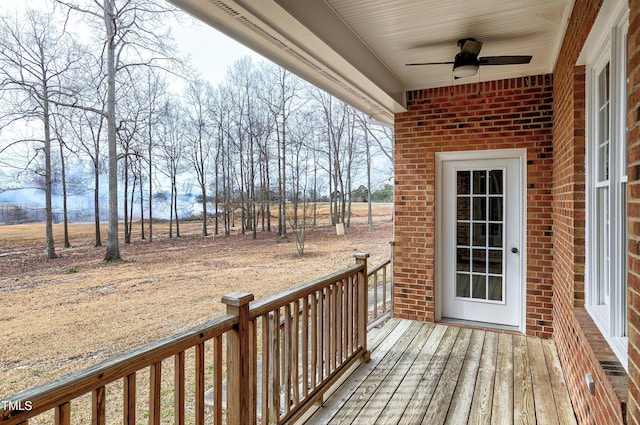 wooden terrace with ceiling fan and a porch