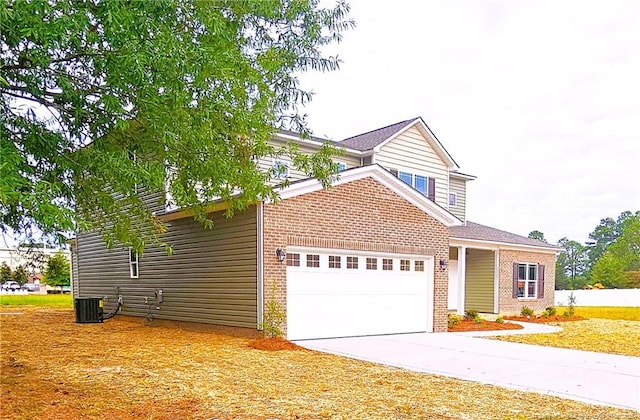 view of front property featuring a garage and central AC unit