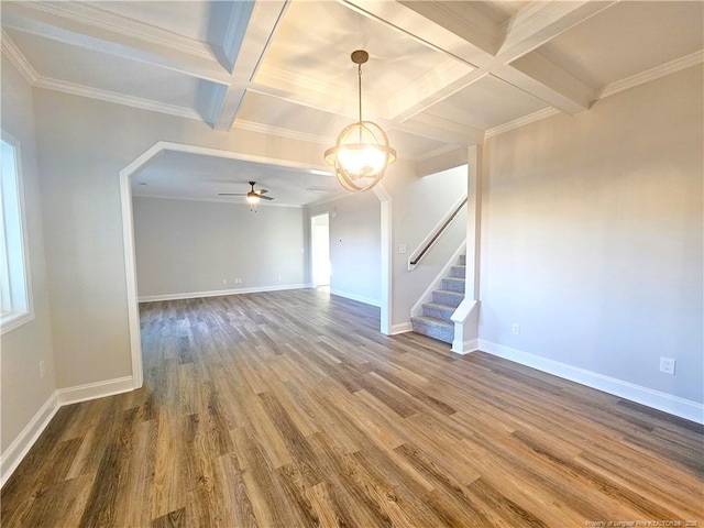 empty room featuring coffered ceiling, beamed ceiling, crown molding, ceiling fan, and hardwood / wood-style flooring