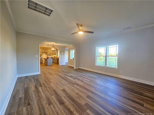 unfurnished living room featuring dark hardwood / wood-style flooring, ceiling fan, and crown molding