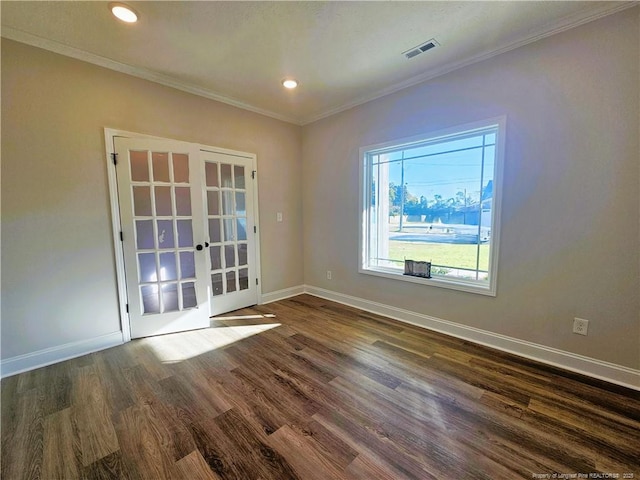 empty room with dark hardwood / wood-style floors, french doors, and ornamental molding