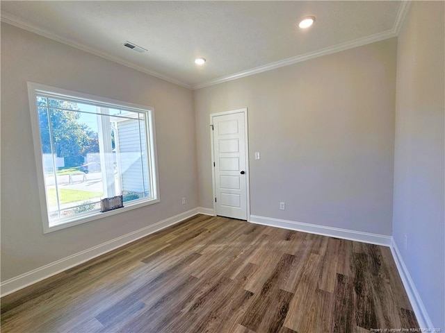 unfurnished room featuring hardwood / wood-style flooring and crown molding