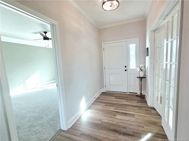 entrance foyer with hardwood / wood-style flooring, ceiling fan, and ornamental molding