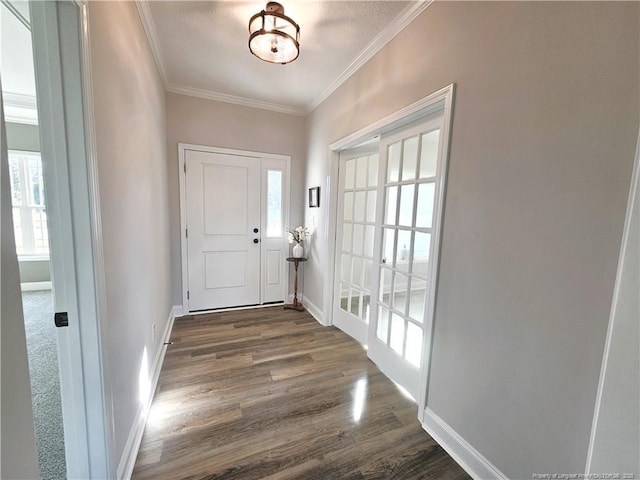 foyer entrance with crown molding and dark hardwood / wood-style floors