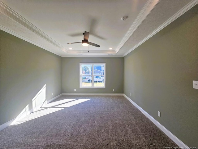 carpeted empty room with ceiling fan, crown molding, and a raised ceiling