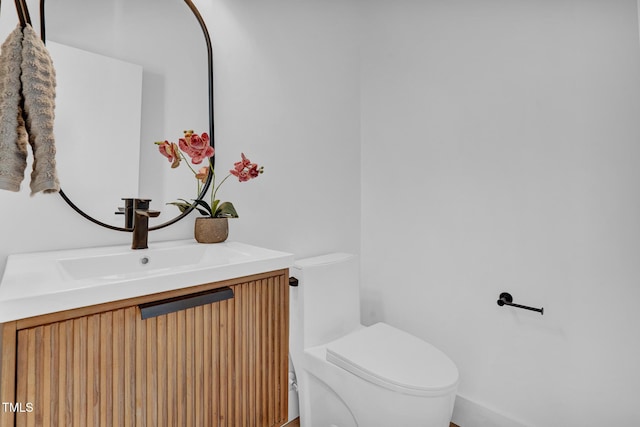 bathroom with toilet and vanity