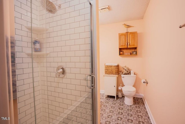 full bathroom with toilet, a stall shower, baseboards, and tile patterned floors