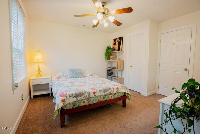 bedroom featuring carpet floors, a ceiling fan, and baseboards