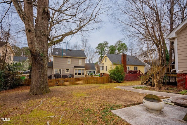 view of yard with fence private yard, a deck, and stairs