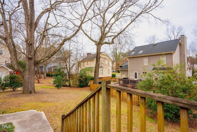 deck featuring a residential view and a yard