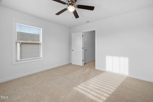 unfurnished bedroom with light colored carpet, ceiling fan, visible vents, and baseboards