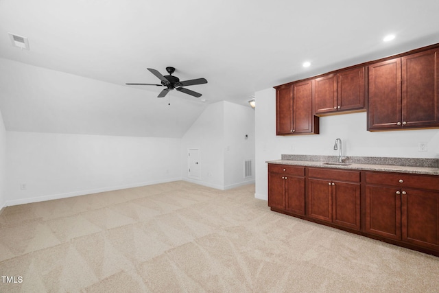 kitchen with light carpet, visible vents, light countertops, and a sink