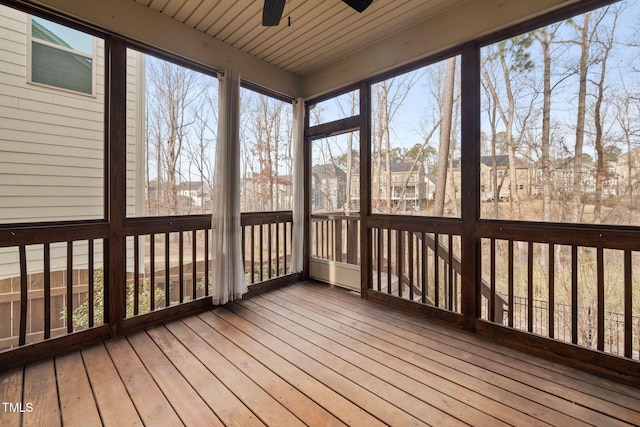 unfurnished sunroom featuring ceiling fan