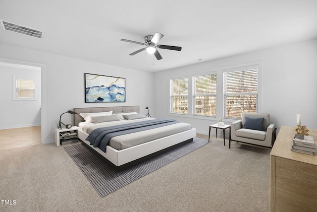 bedroom with baseboards, visible vents, ceiling fan, and carpet flooring