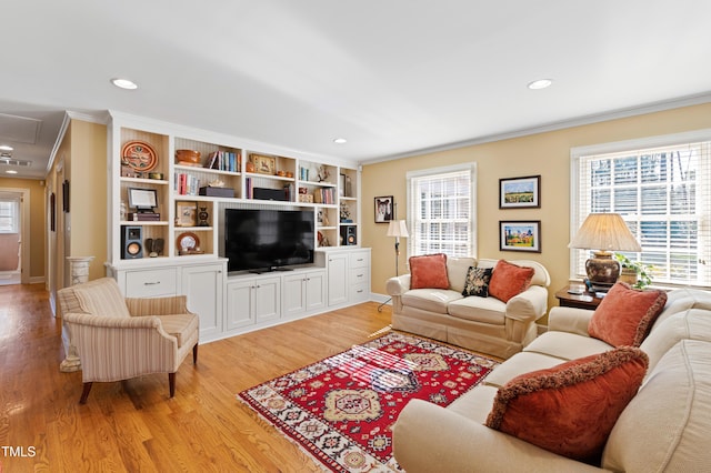 living room with ornamental molding, light wood-type flooring, attic access, and recessed lighting