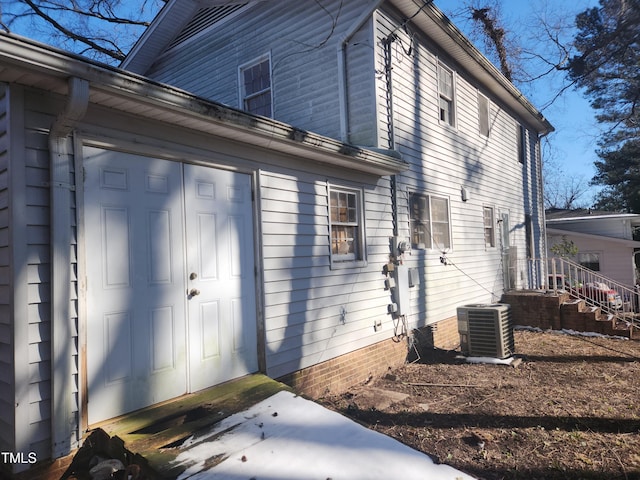 view of side of home featuring central AC unit