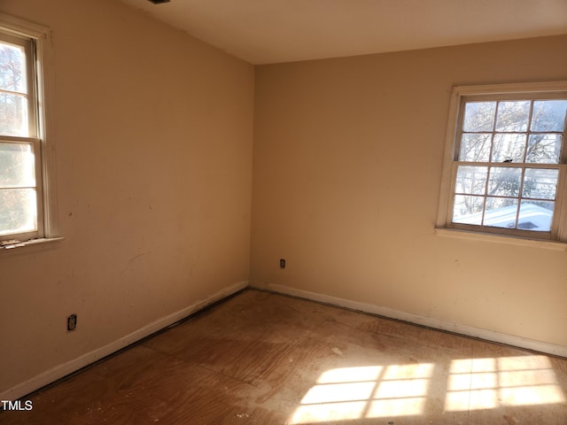 spare room featuring baseboards