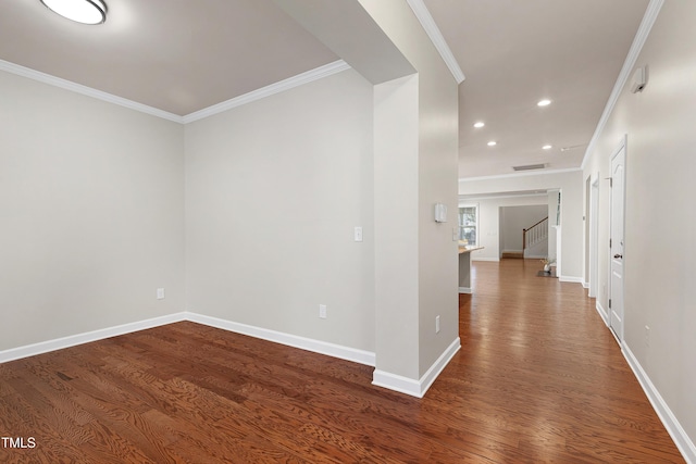 spare room with hardwood / wood-style flooring and crown molding