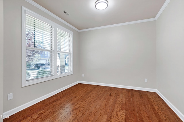 spare room featuring ornamental molding and hardwood / wood-style floors