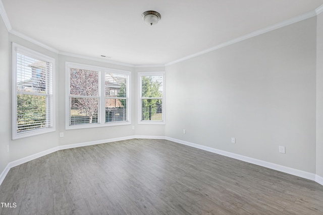 unfurnished room featuring ornamental molding and hardwood / wood-style flooring