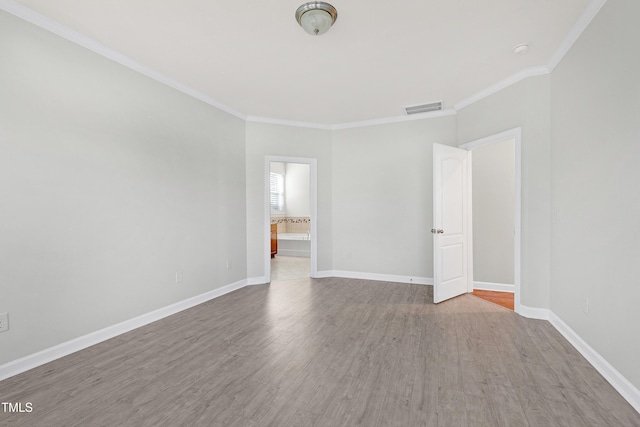 unfurnished room with ornamental molding and wood-type flooring