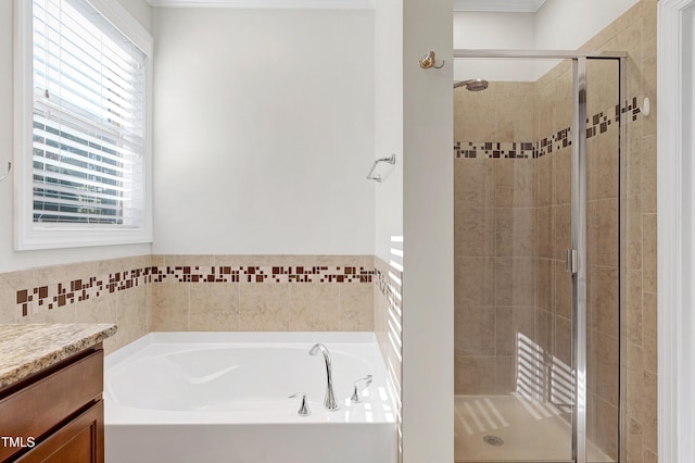 bathroom featuring vanity and shower with separate bathtub