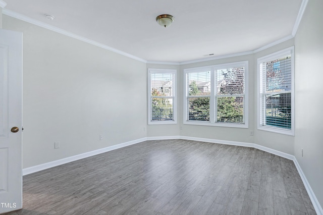 empty room featuring ornamental molding and hardwood / wood-style flooring