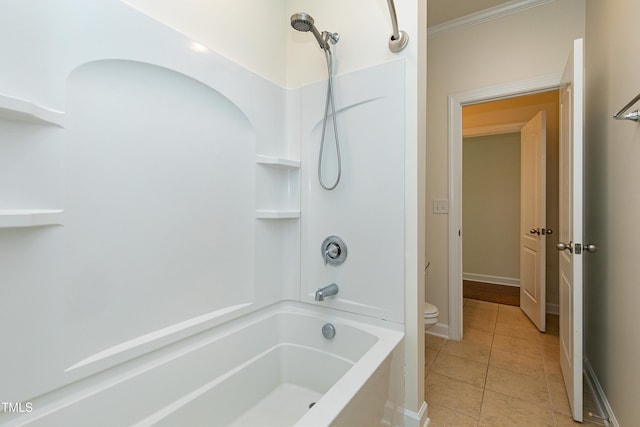 bathroom featuring tile patterned floors, toilet, crown molding, and shower / washtub combination