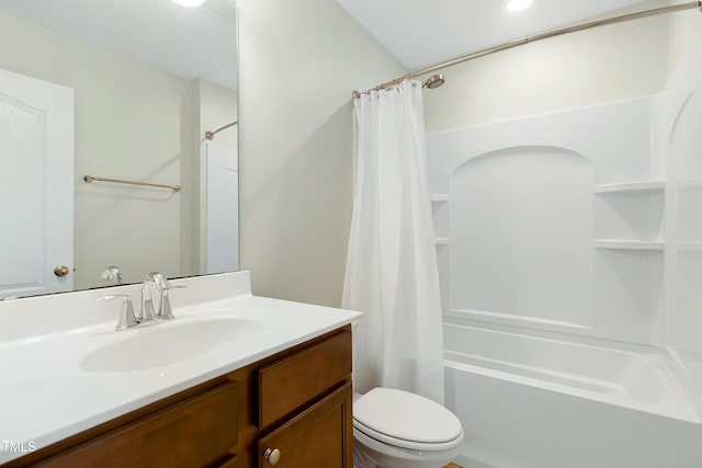 full bathroom with toilet, vanity, and shower / tub combo