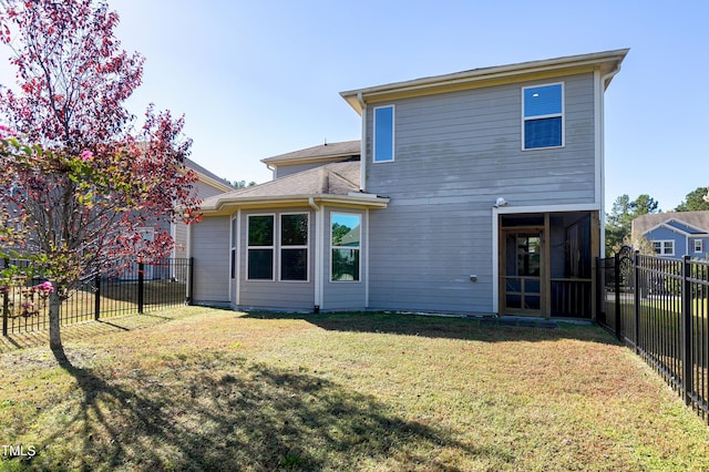 rear view of property with a yard