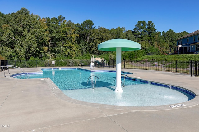 view of swimming pool with a patio and pool water feature