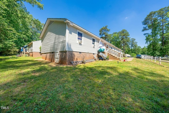 view of side of home featuring a lawn