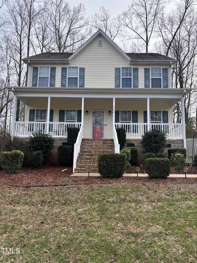 view of front of property with covered porch and a front lawn