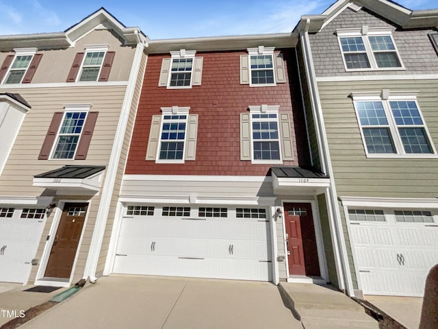 view of property with driveway and a garage