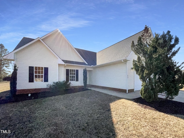 view of front of property with an attached garage and a front yard