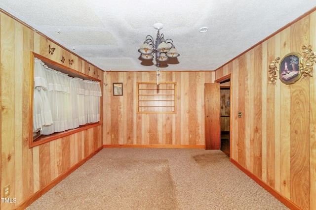 811 Queens St NW, Lenoir, NC 28645 - unfurnished room featuring wooden walls, a chandelier, crown molding, carpet, and a textured ceiling