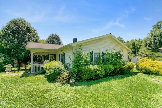811 Queens St NW, Lenoir, NC 28645 - view of side of home with a yard, covered porch, and a chimney