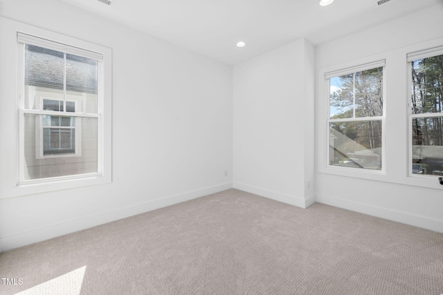 unfurnished room featuring light carpet, recessed lighting, and baseboards