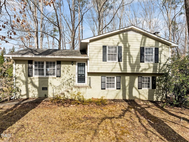 split level home with brick siding and crawl space